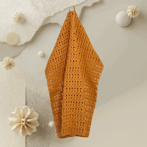 Käsin virkattu sametti-keltainen pyyhe.